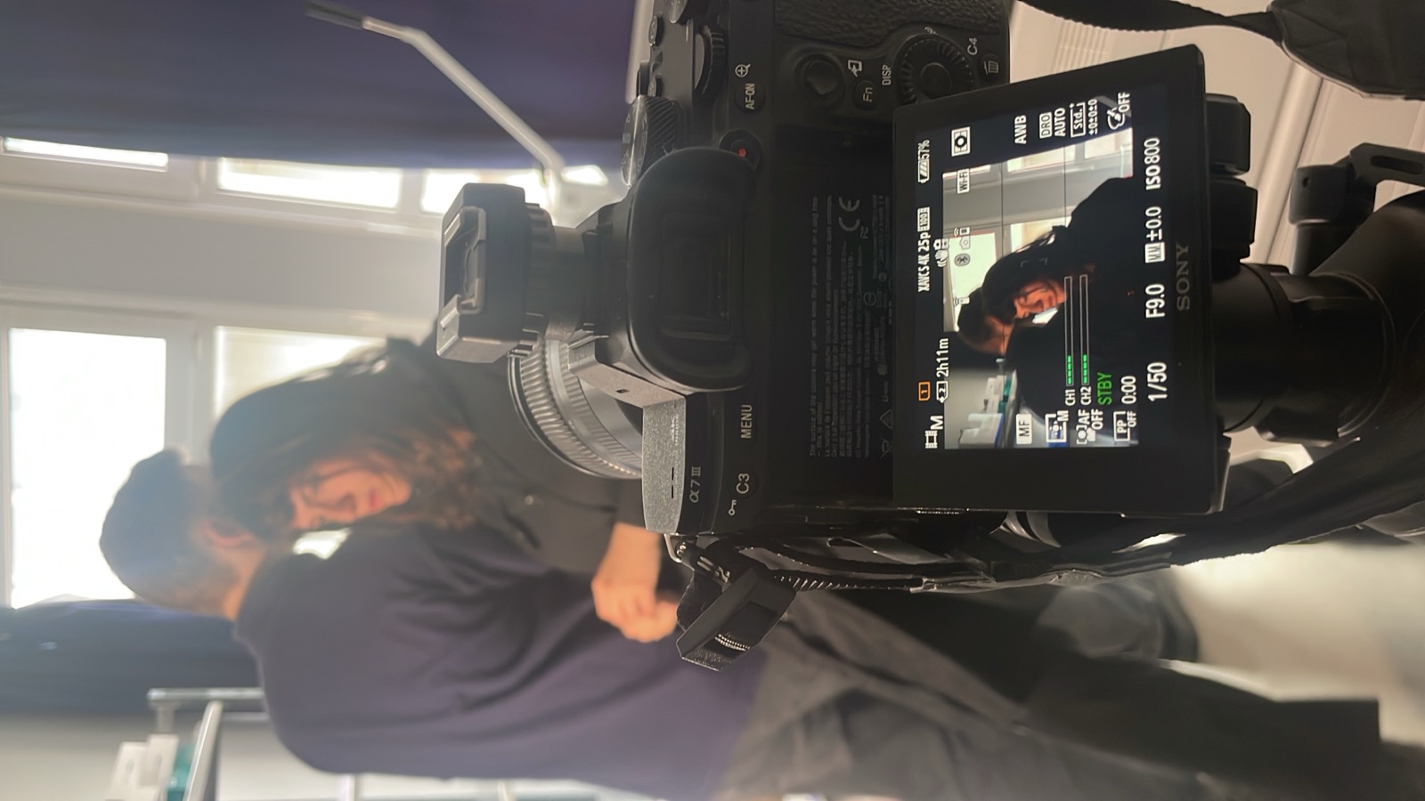Camera operator filming a scene on set